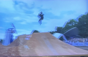 orginal photo of flip - Looks like a BMX rider doing a bike flip off a ramp—specifically an aerial trick where the bike rotates backward/forward in midair before landing. If you tell me which direction it flips (toward the rider or away) and whether the wheels land level or not.