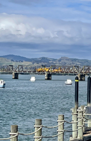 yellow train on bridge